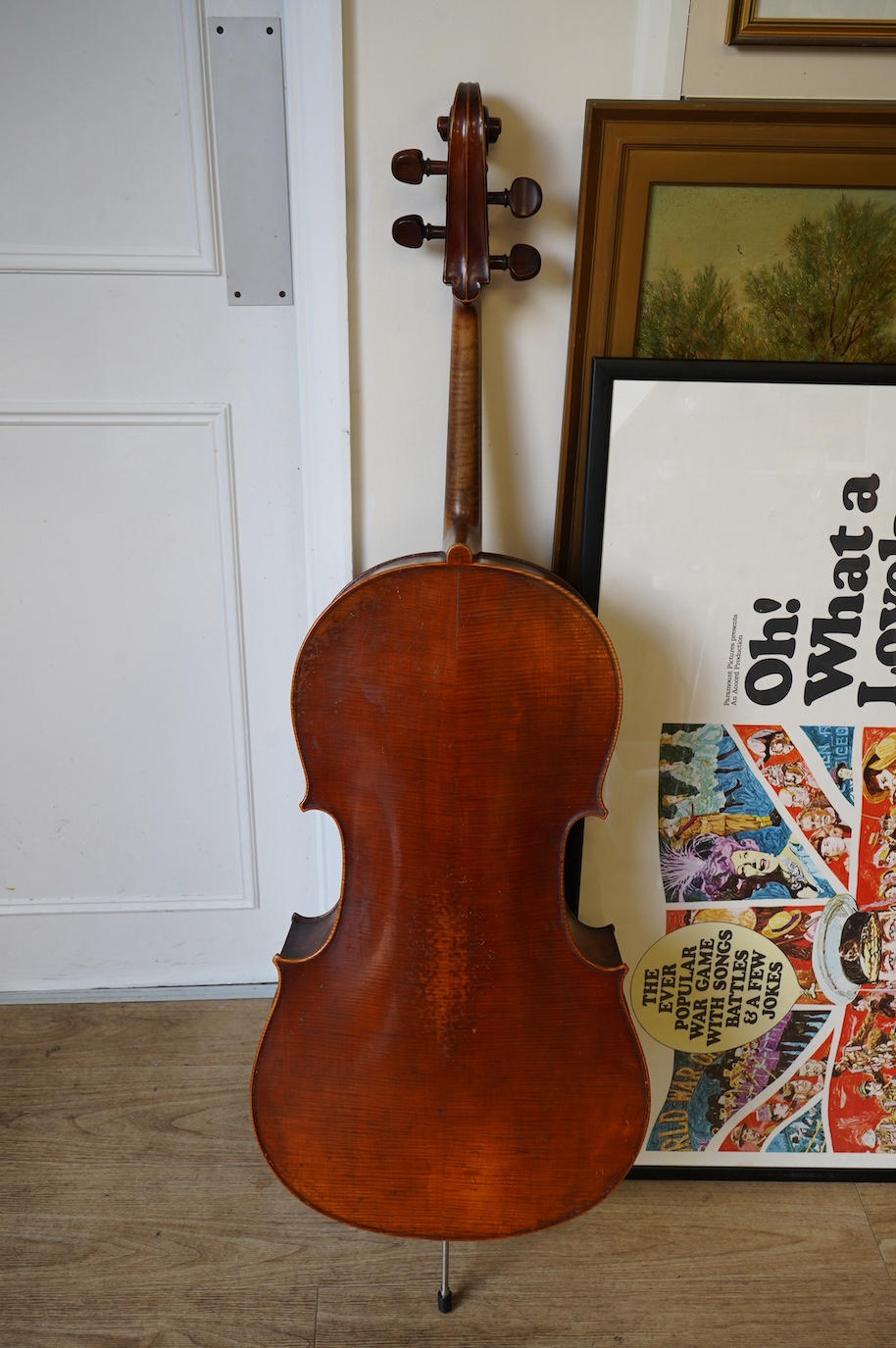 An early 19th century cello with a Stradivarius label, body 76cm, with a P&H bow, in a good modern case. Condition - poor